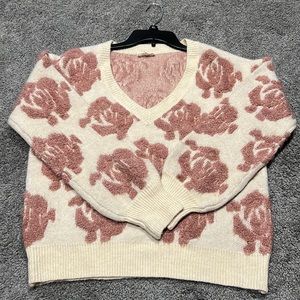 Cream sweater with beautiful pink rosettes. Love it and only wore it once!